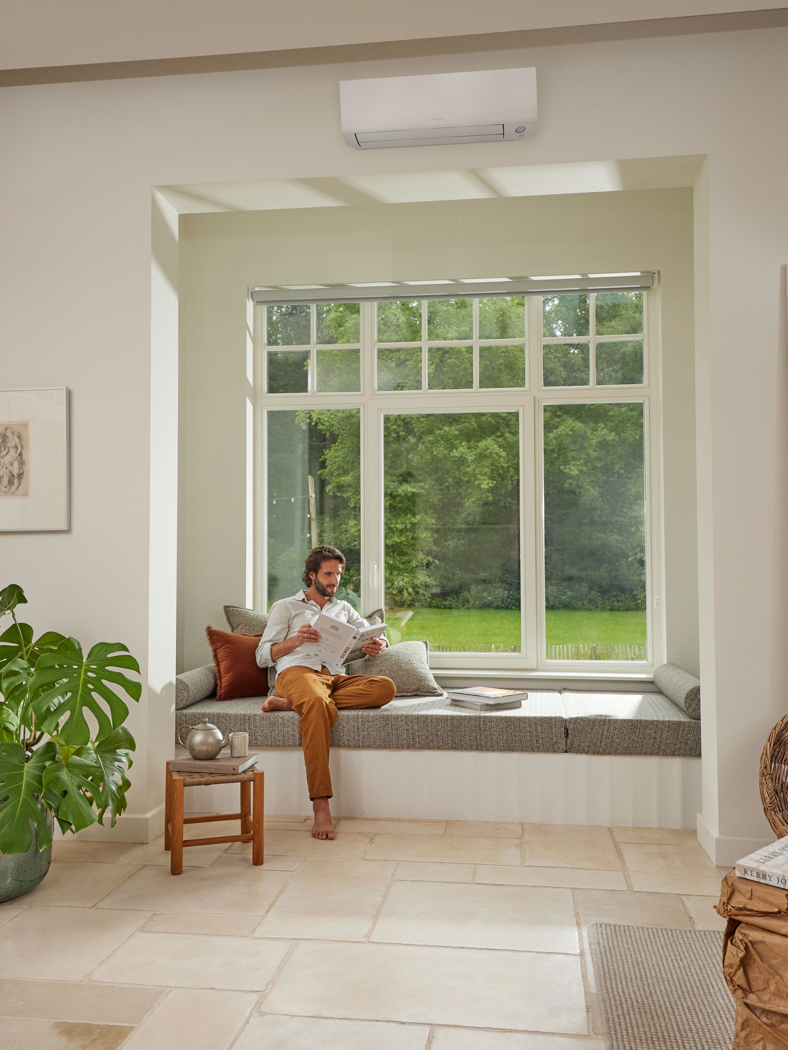 Man reading below heat pump