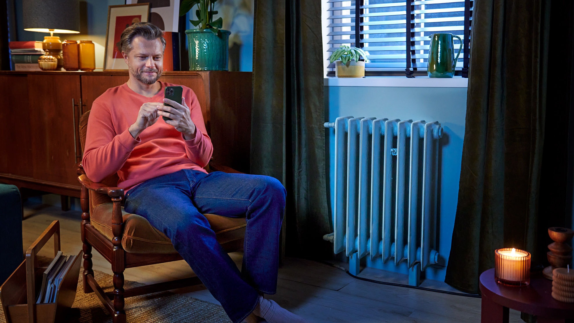 Man using Onecta app to control his air-to-water heat pump
