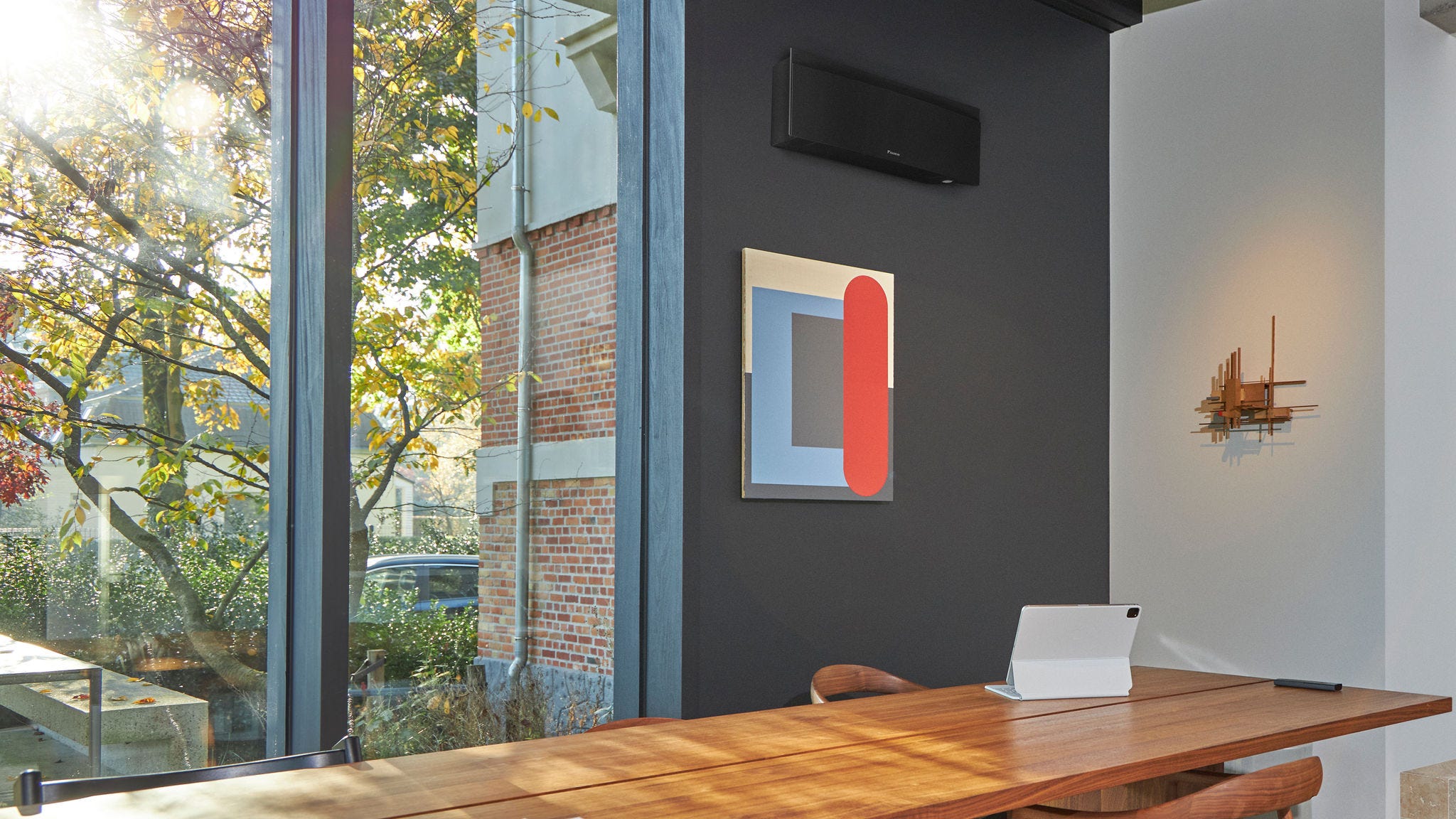 A discreet, properly-sized, black wall-mounted heat pump