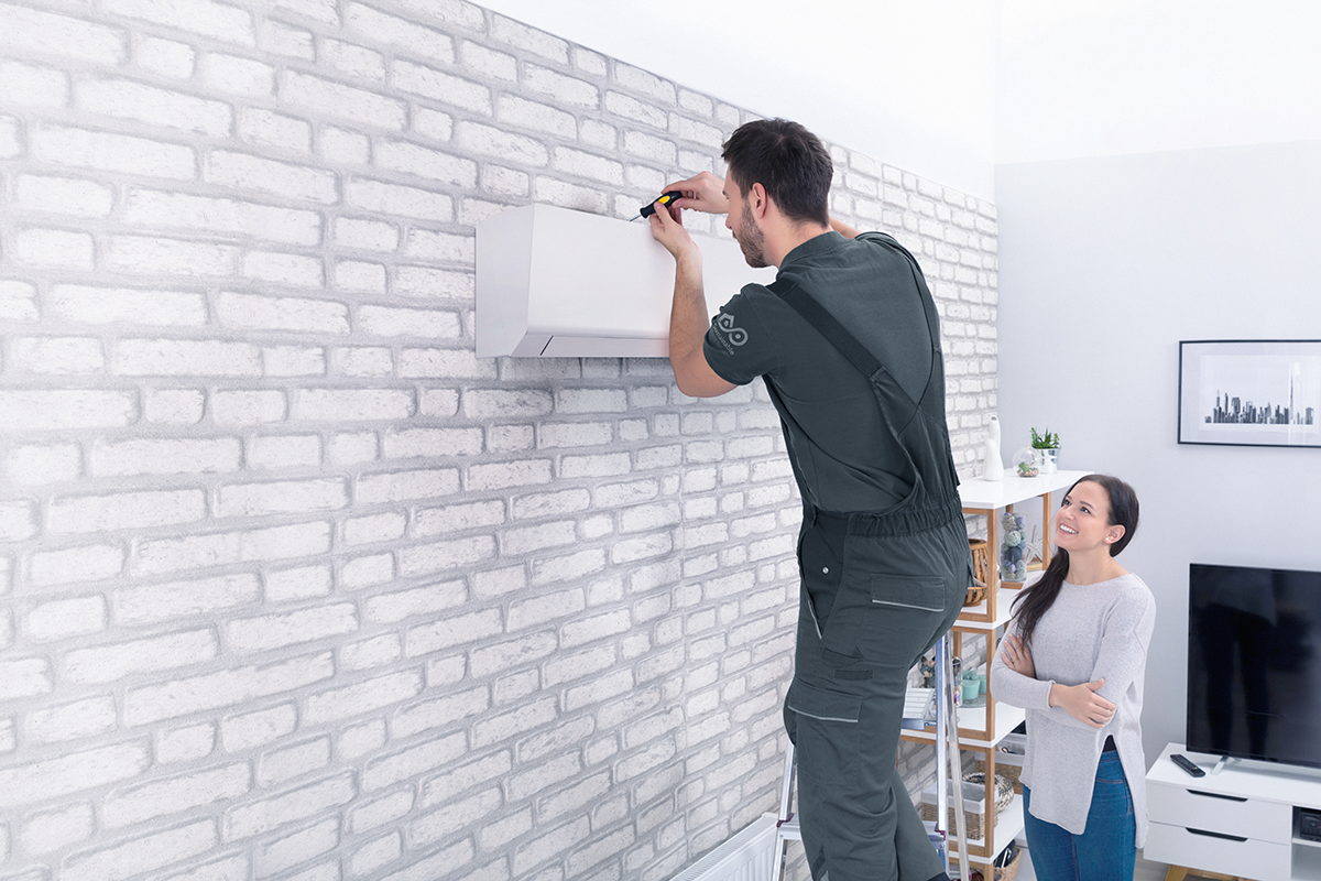 Installer with homeowners looking at controller