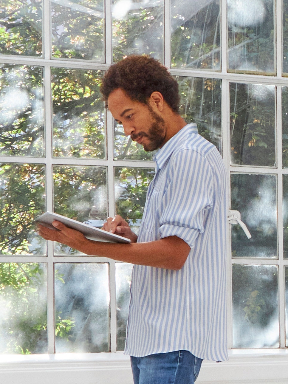 Man in front of window, in well-ventilated room to prevent condensation and moisture build-up