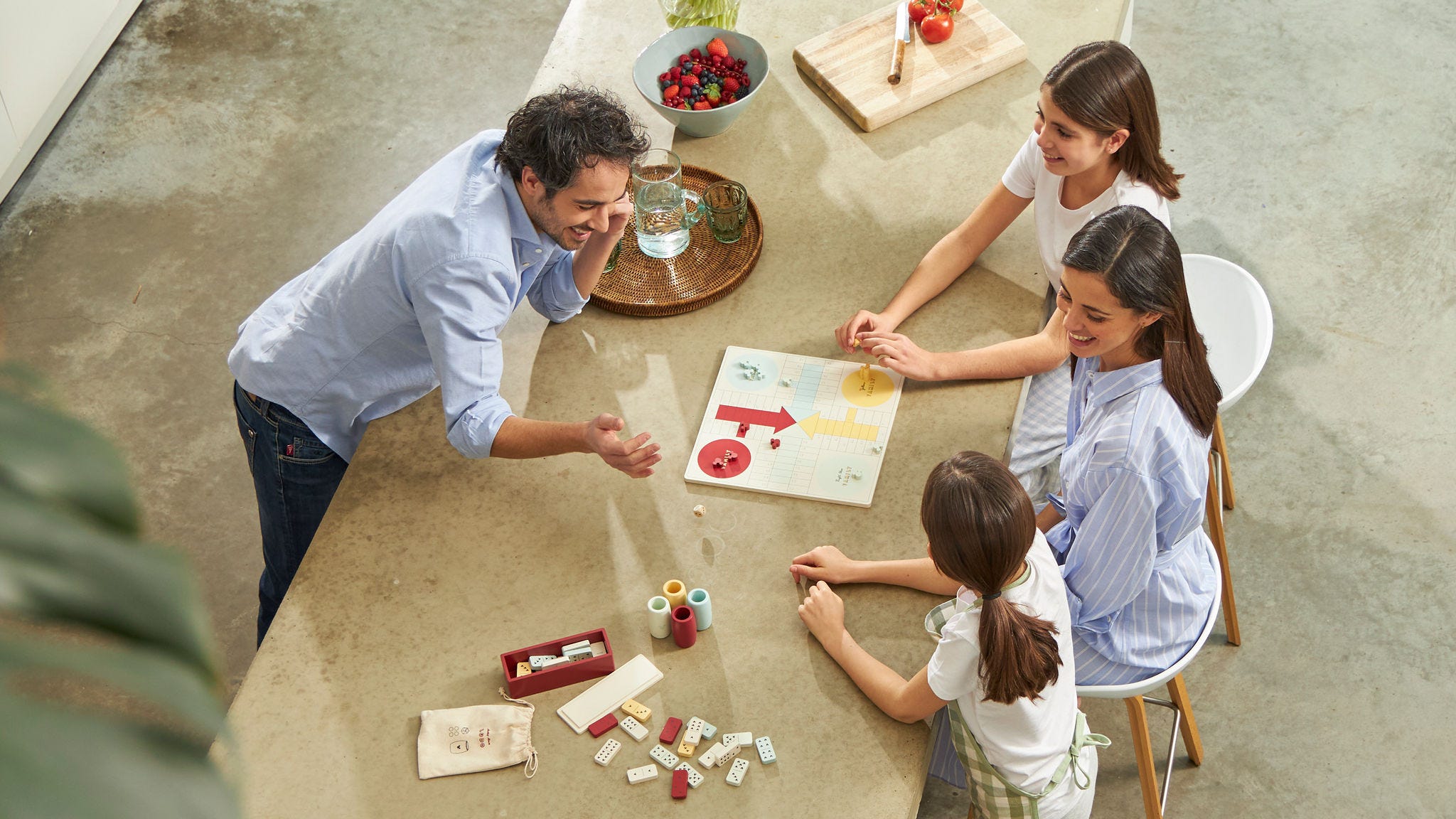 Family with two kids playing a game at the kitchen table in their energy-neutral home