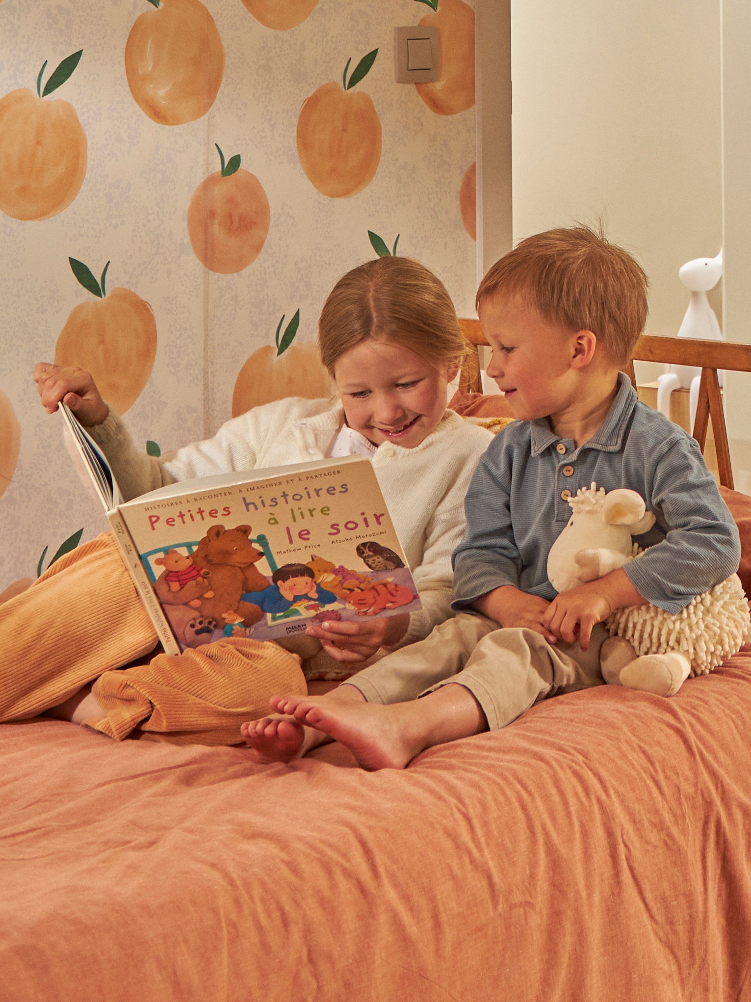 Kids reading book in bed