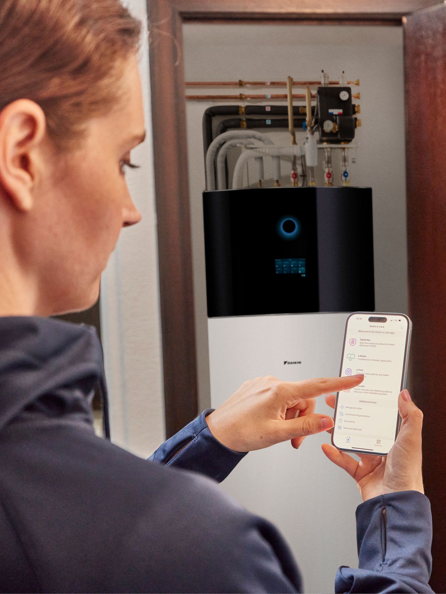 Woman controlling her heat pump remotely via smartphone in a modern home