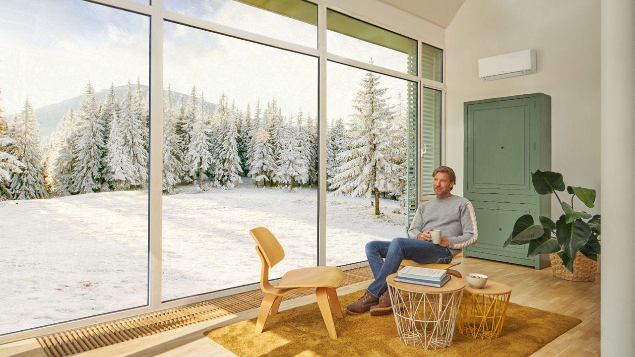 Man sitting in couch and enjoying heating with air conditioner