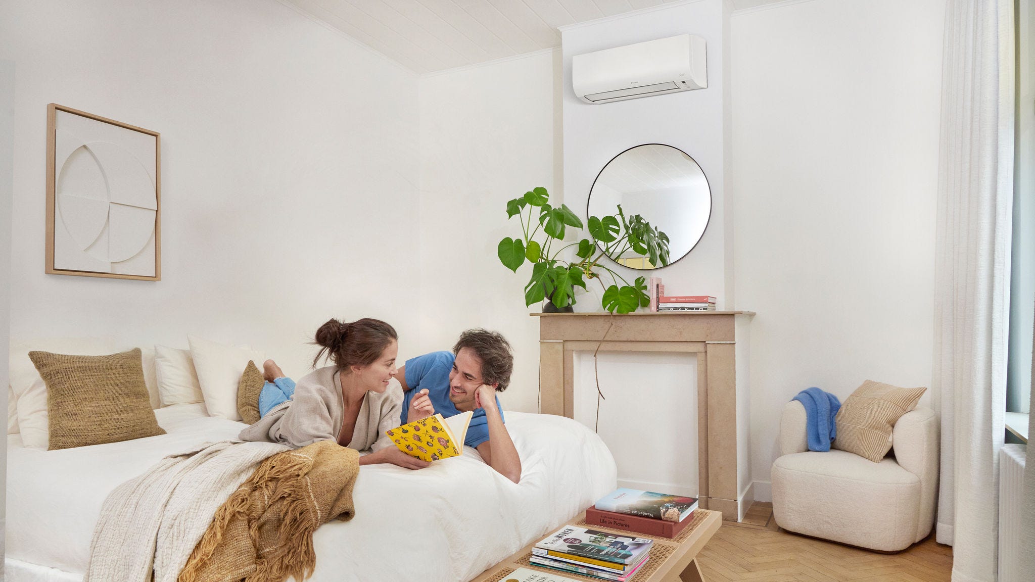 Woman sitting in the living room comfortably thanks to Daikin air-to-air heatpums
