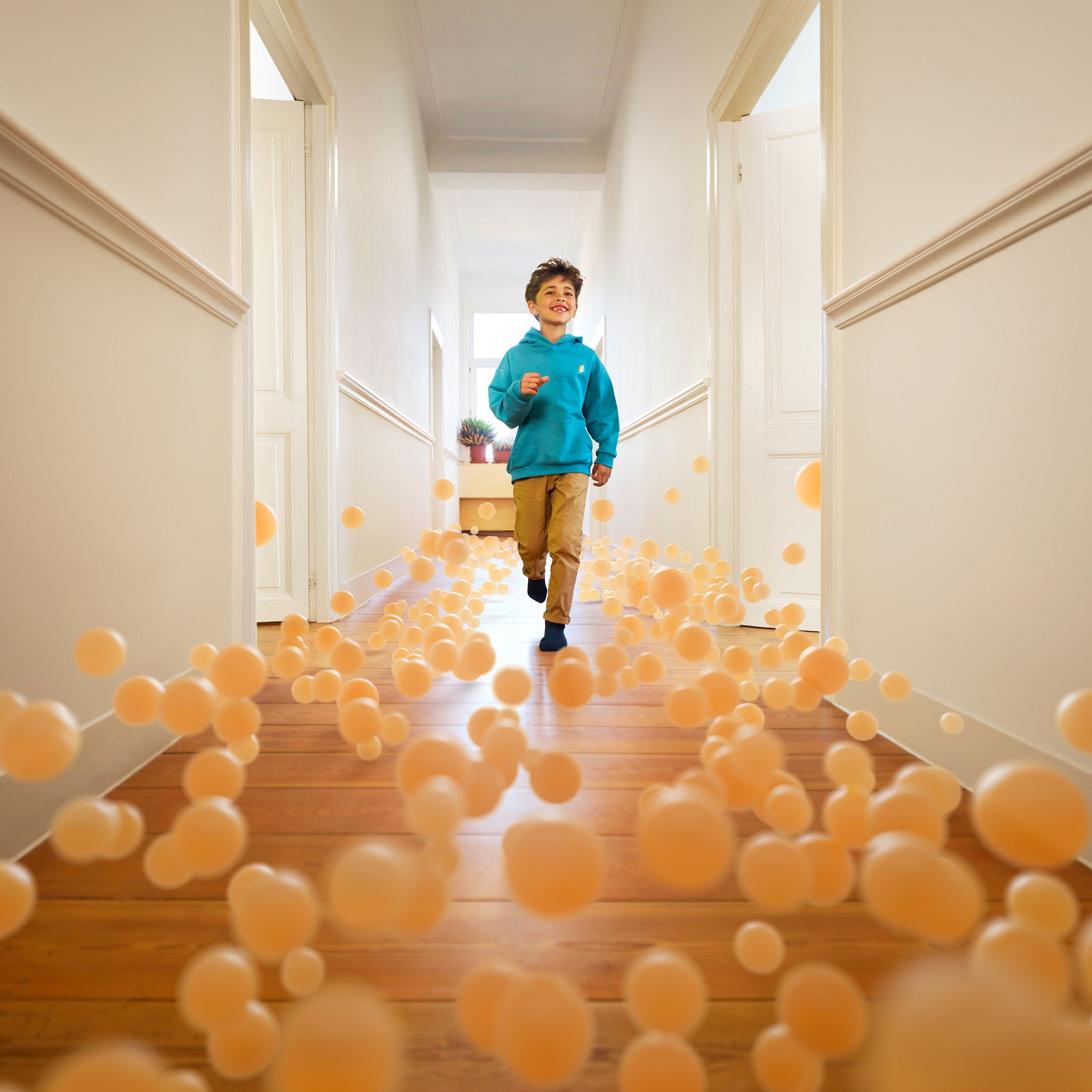 Boy running through hallway of house with perfect temperature because of an air-to-water heat pump