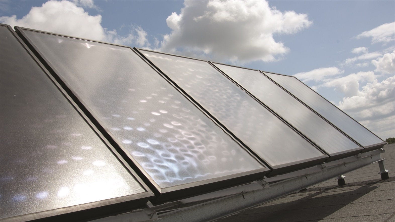 Solar panels powering Daikin heat pump for energy-efficient home heating