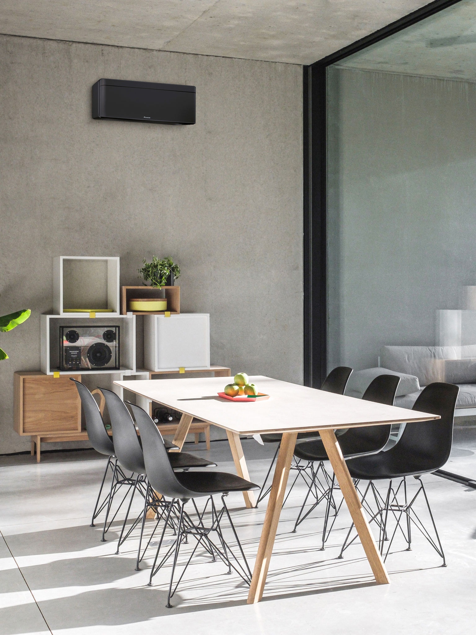 Dining room with big window and a wall-mounted air-to-air heat pump installed
