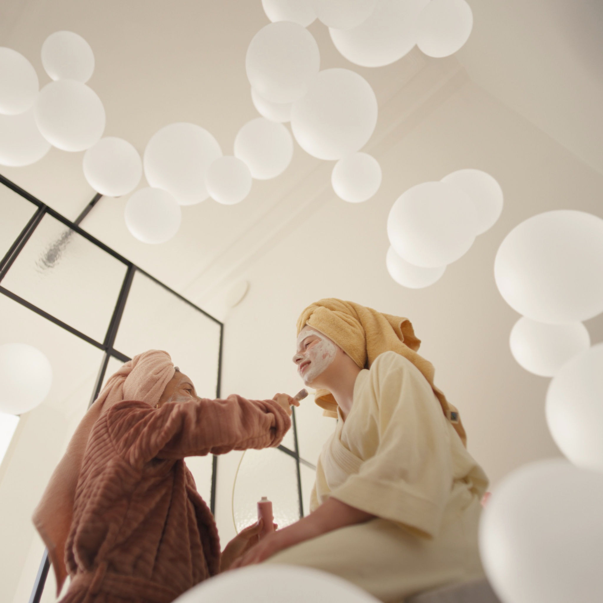 Mother and daughter enjoying self-care with face masks in a well-ventilated room, thanks to a fresh air ventilation system