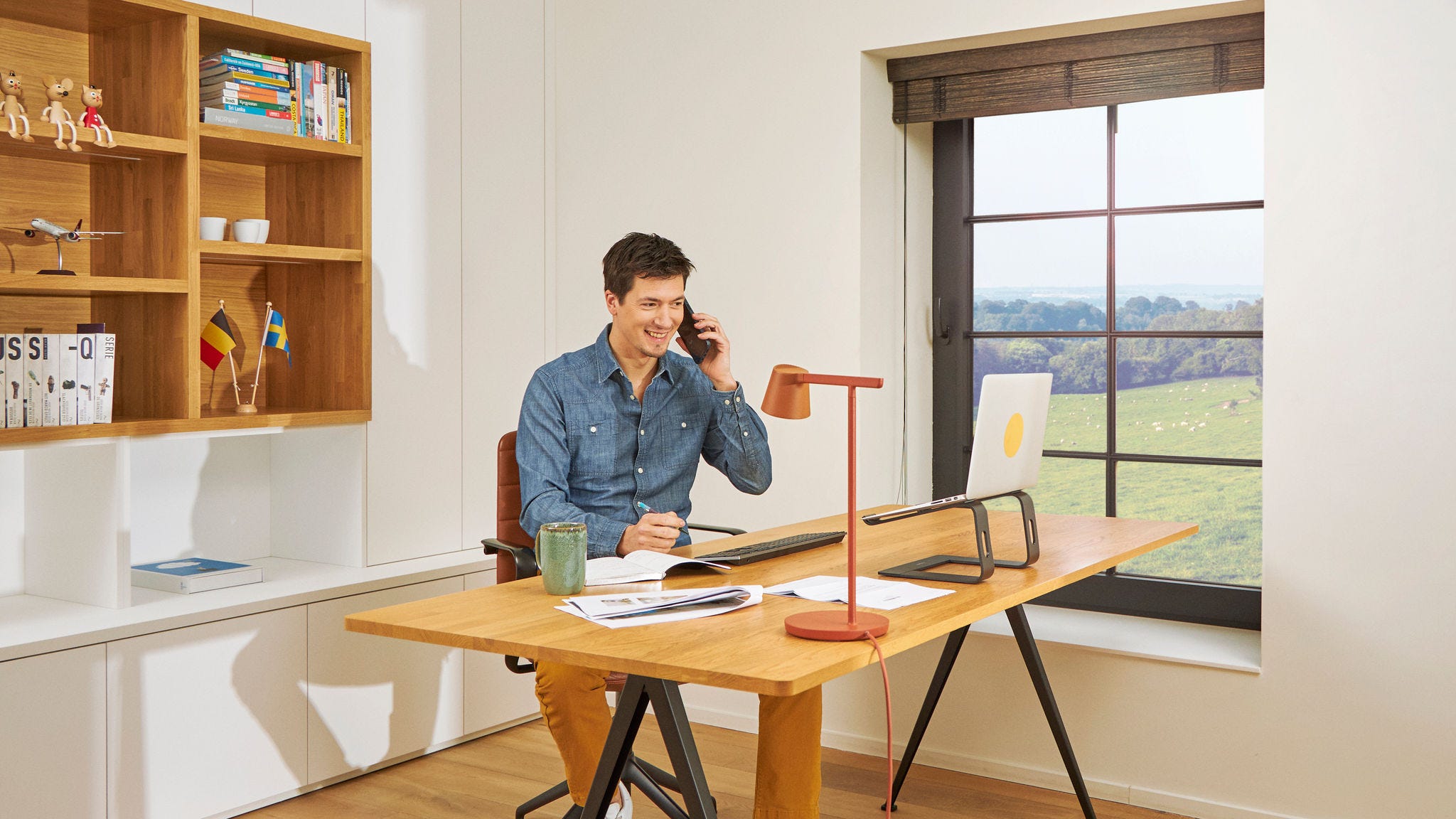 Man at his desk making calls in his home office in quality indoor air