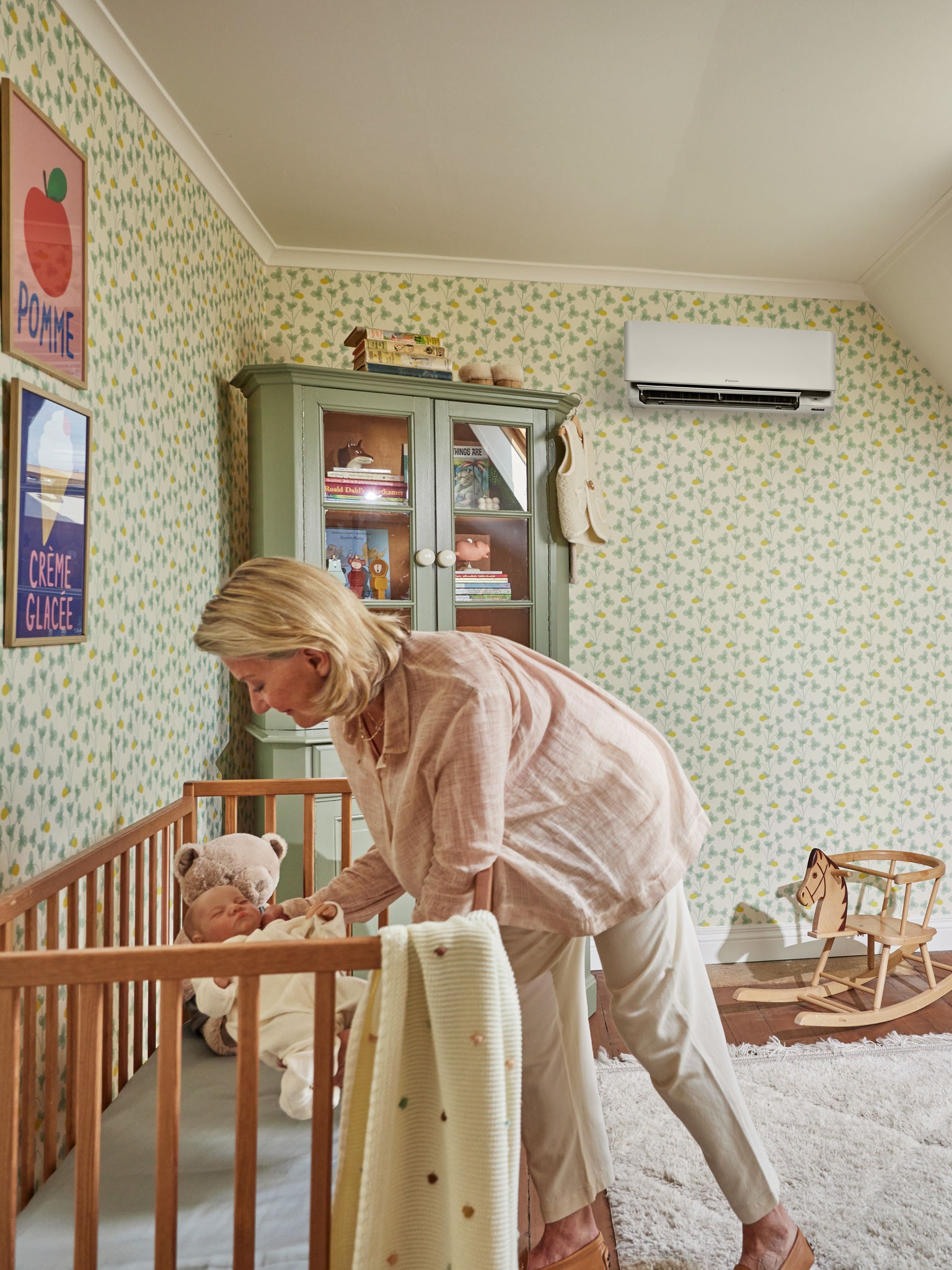 Mother putting her child to bed at night