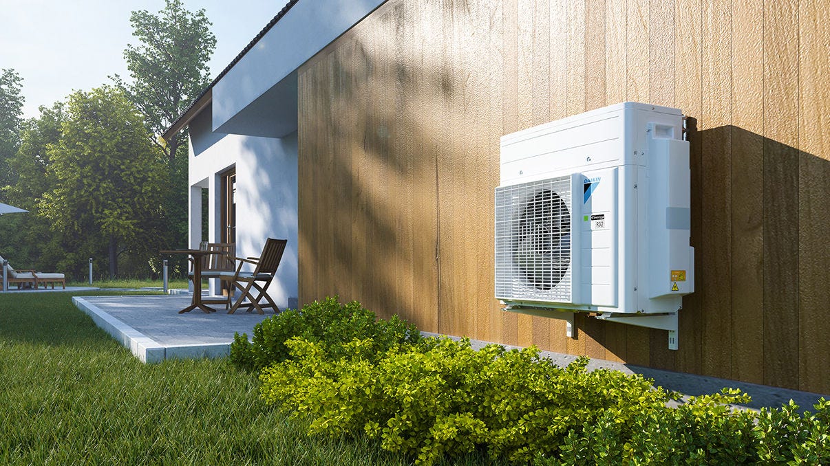 Outdoor unit of a heat pump system installed next to the terrace