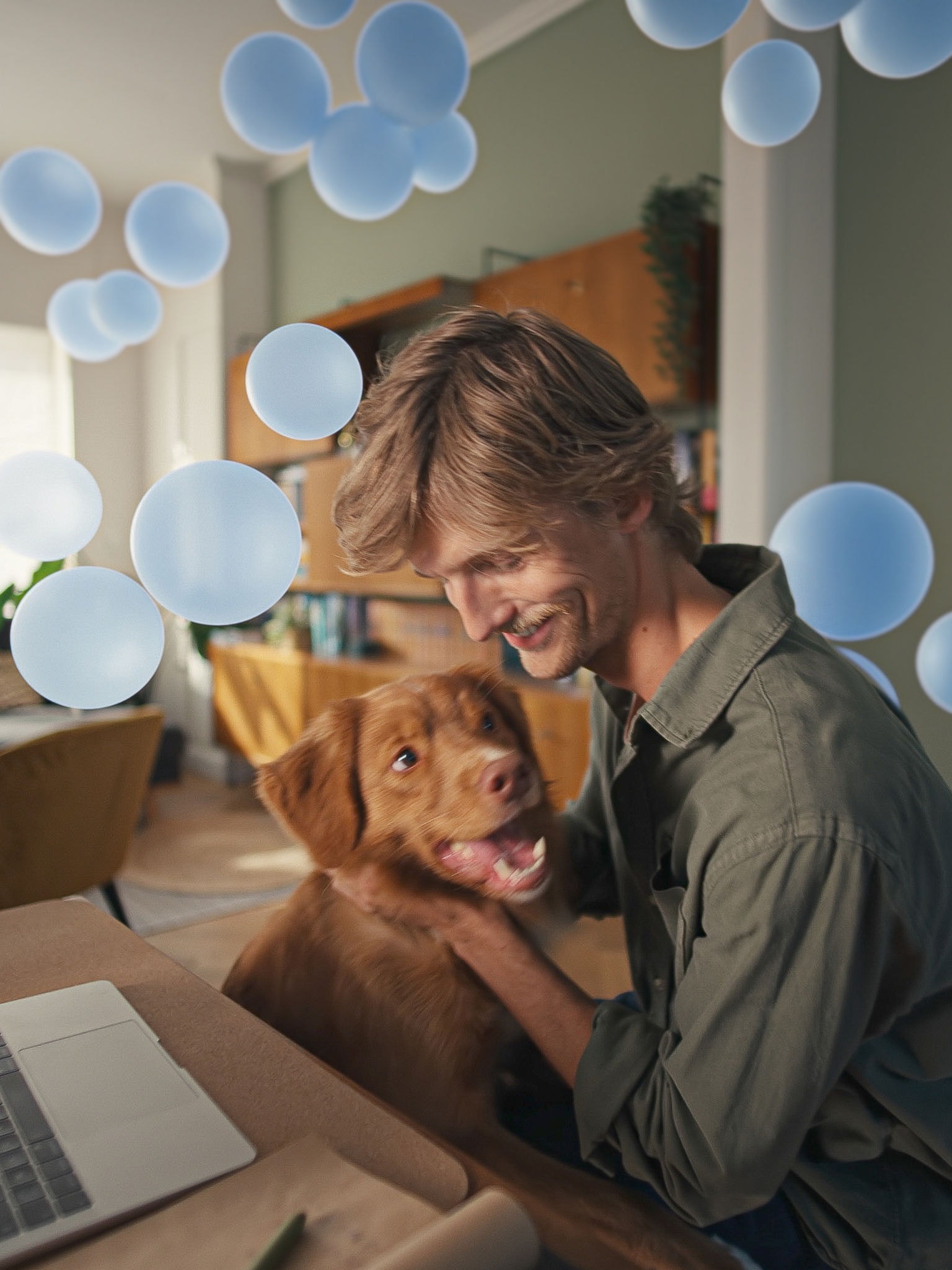 Man and laptop with dog
