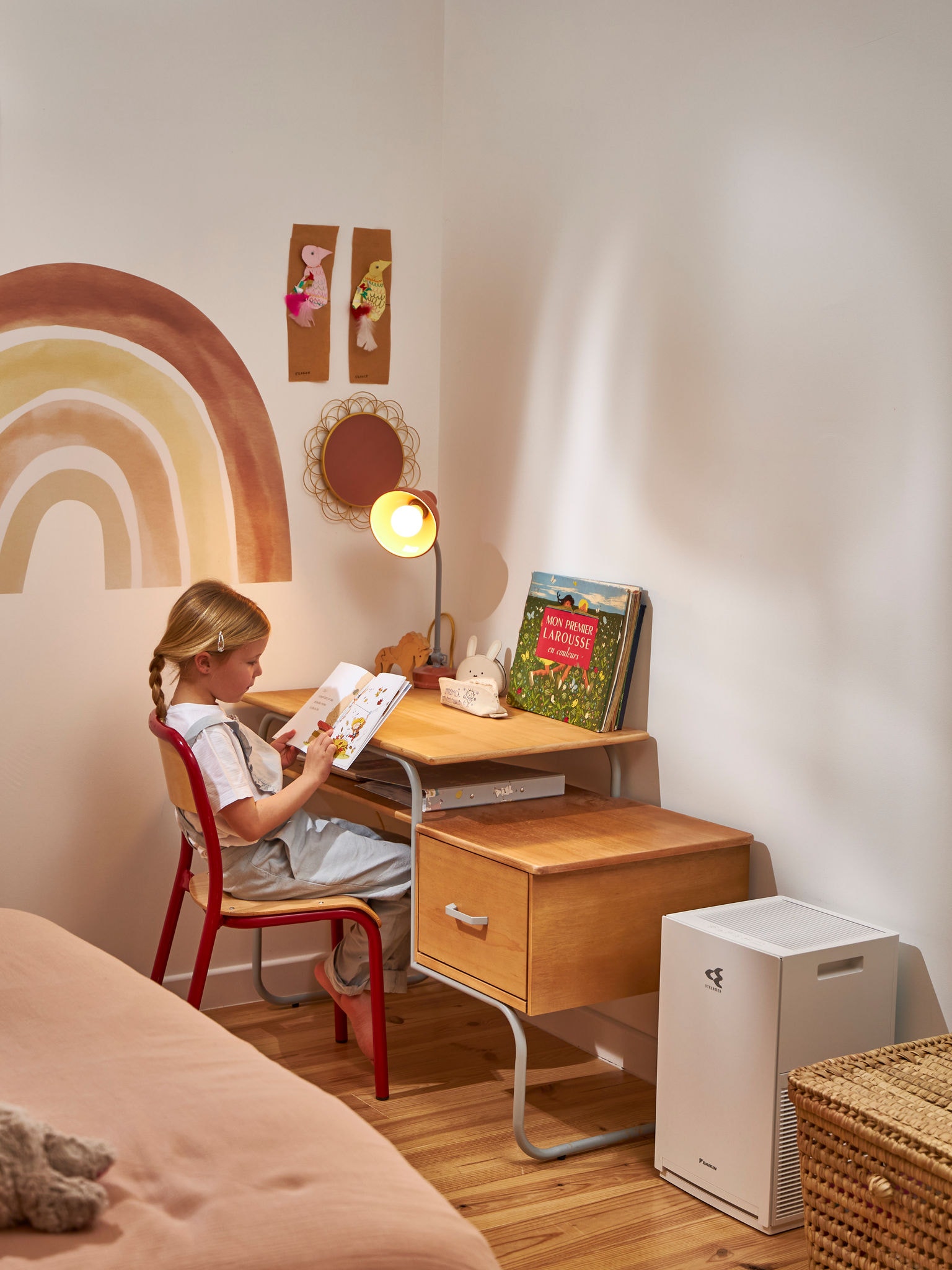 Kid reading next to air purifier