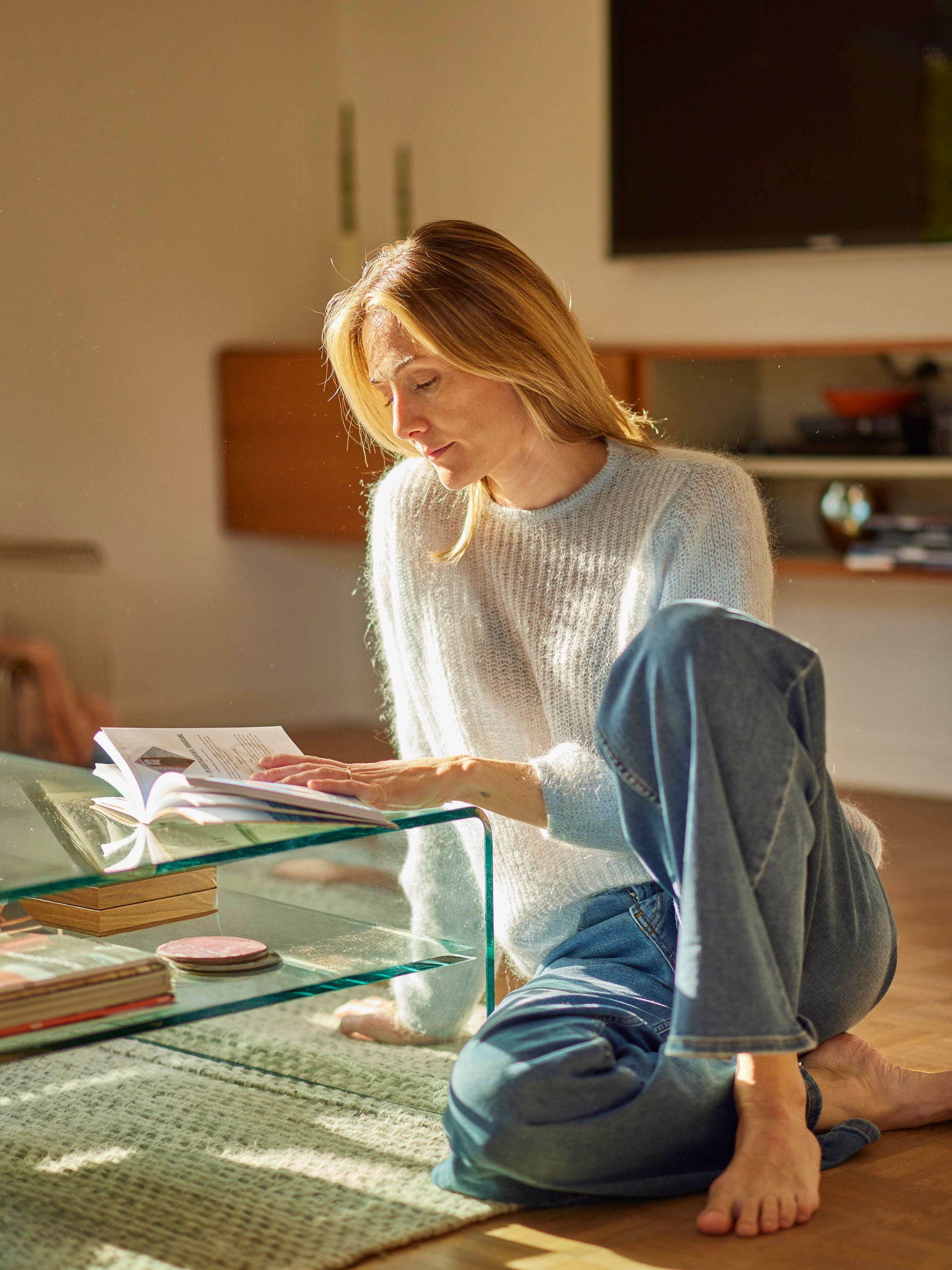 Woman relaxing with a book in an energy-efficient home heated by a heat pump