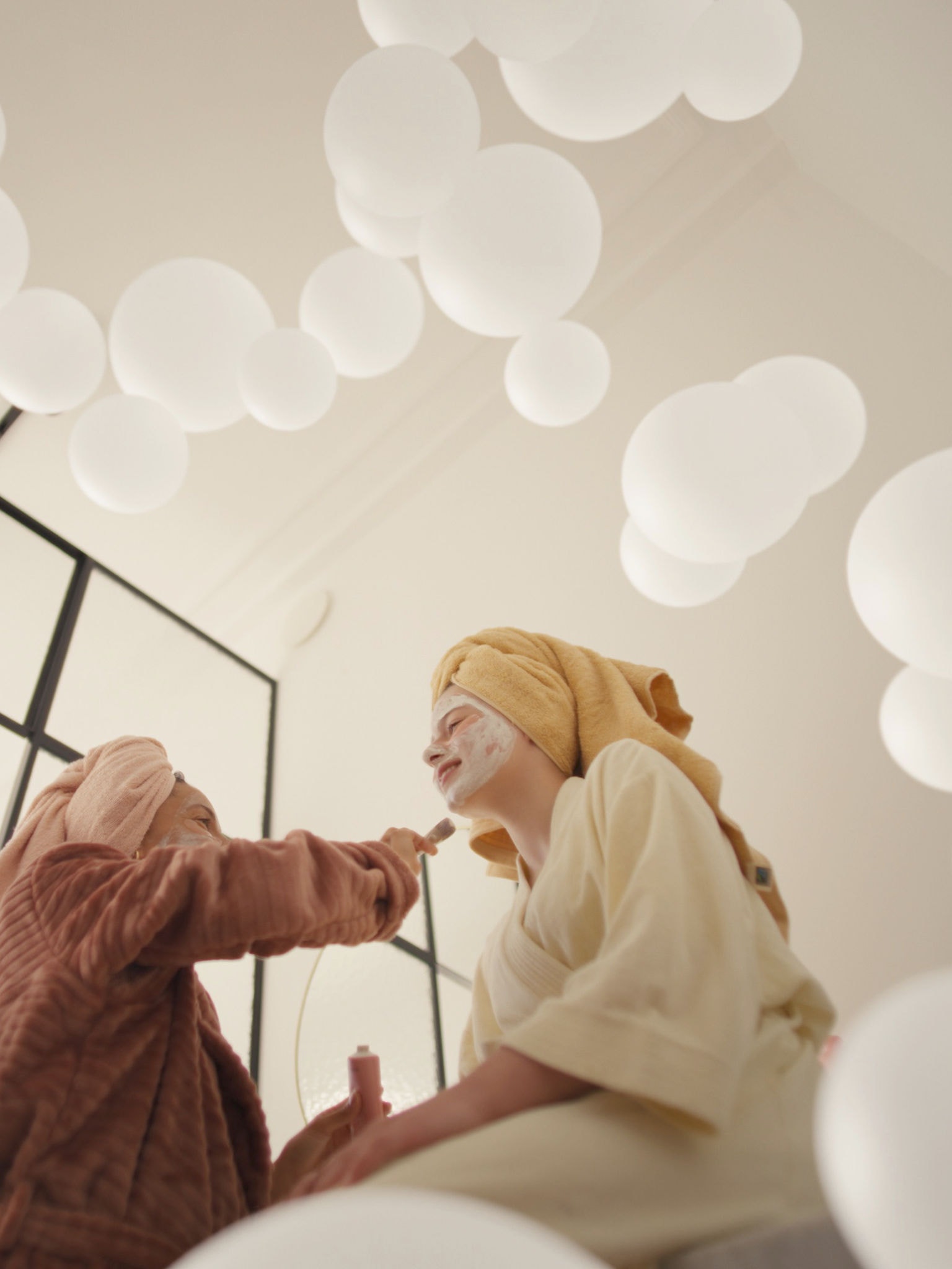 Mother and daughter enjoying self-care with face masks in a well-ventilated room, thanks to a fresh air ventilation system