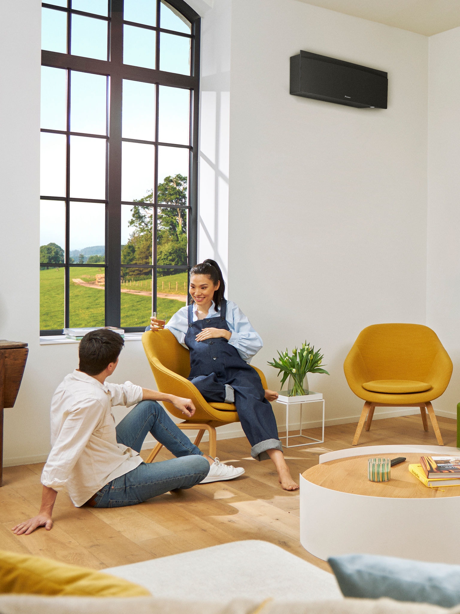 Man and woman on armchair near window