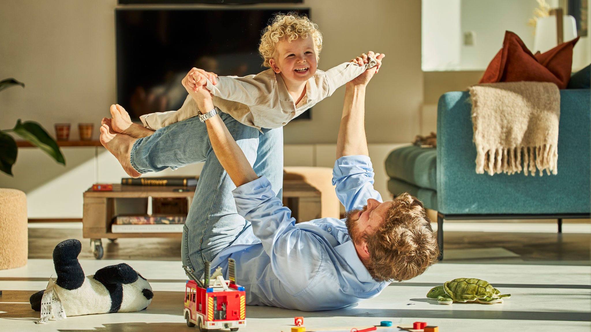 Dad and his child happily playing together and enjoying cool air