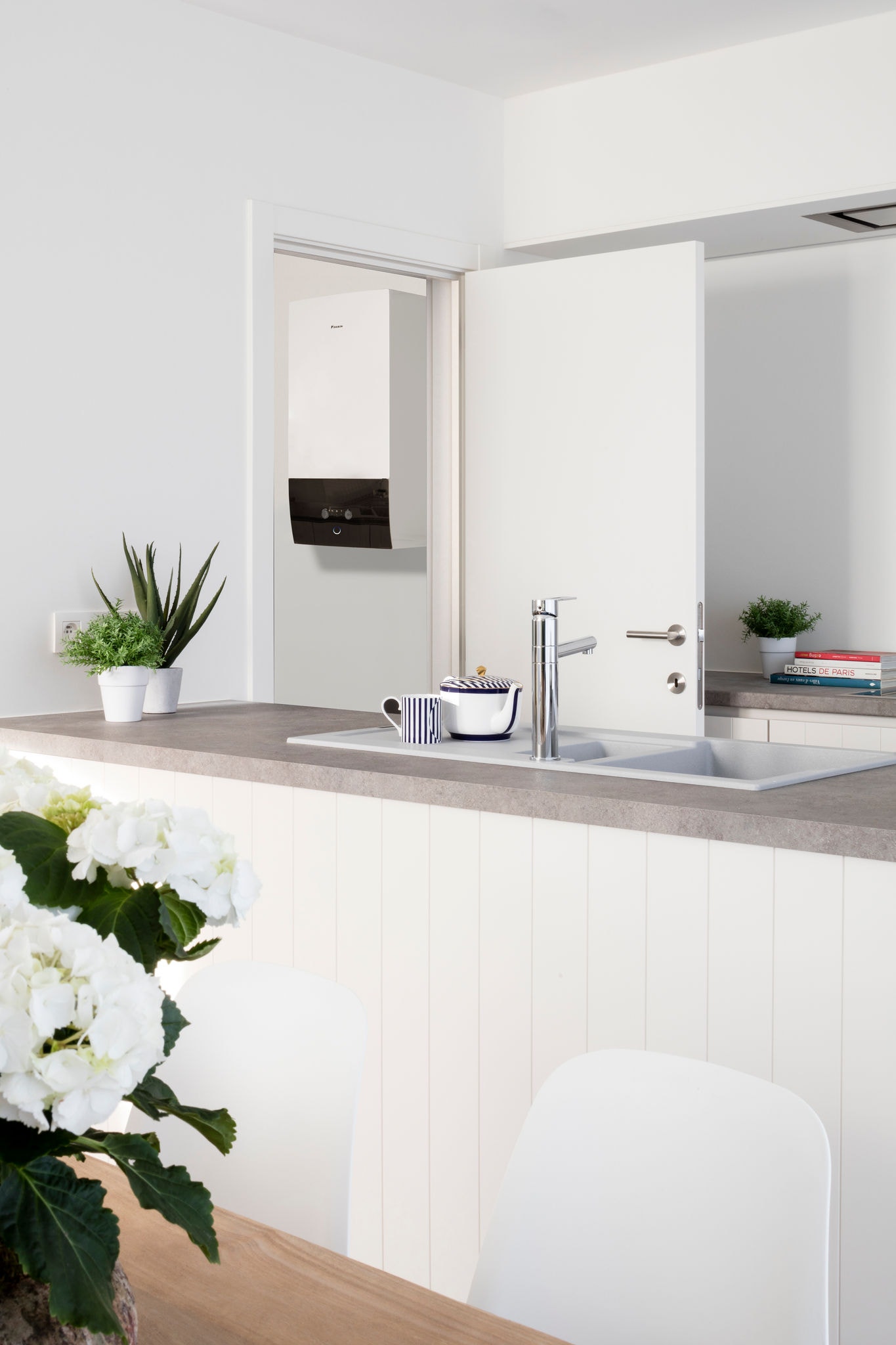 Installed air-to-water heat pump next to a kitchen, showcasing how it increases the value of your property
