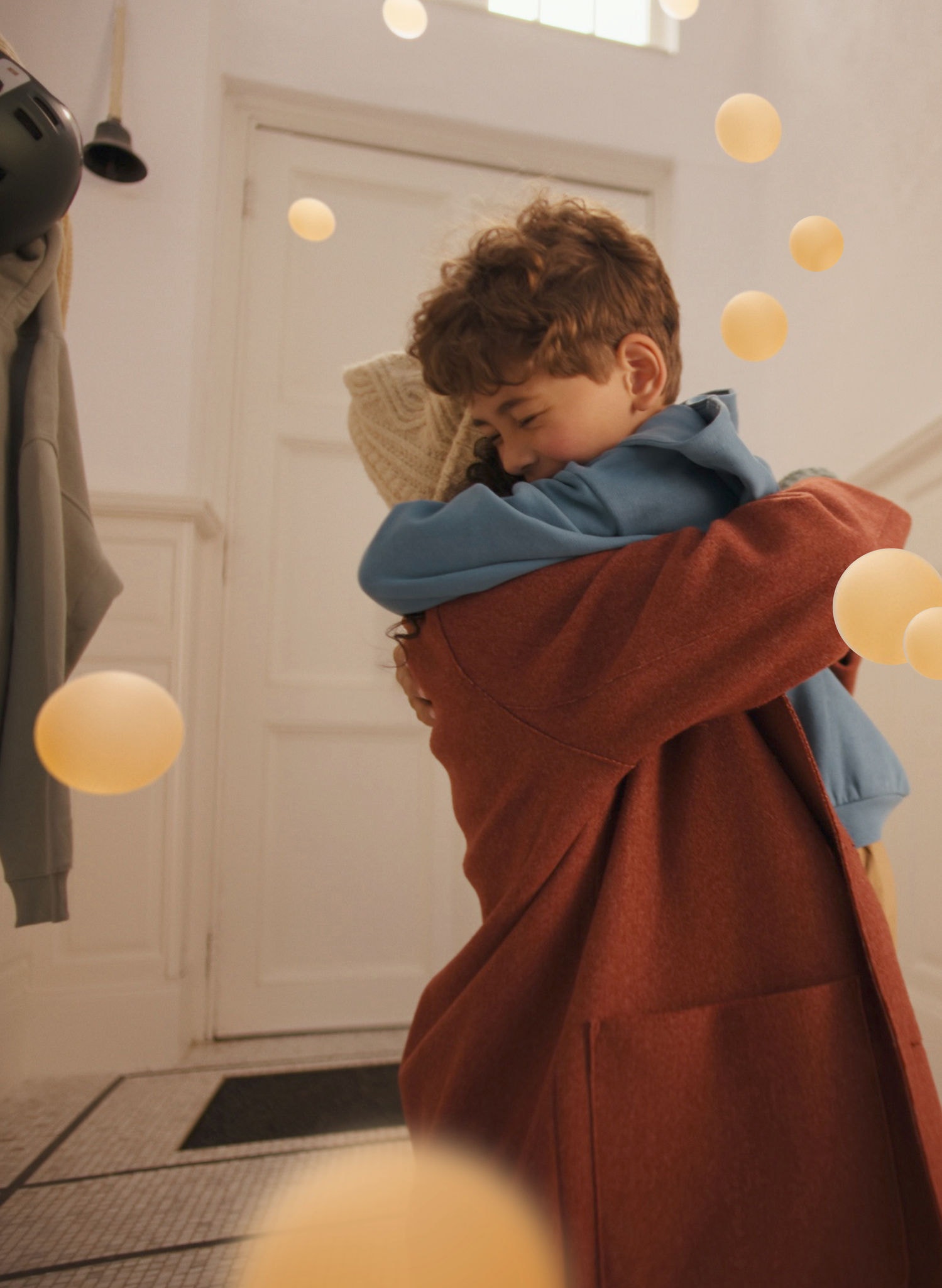 Mother and son sharing a warm hug in a stylish, serene living space, enjoying whisper-quiet comfort from a Daikin air-to-air heat pump