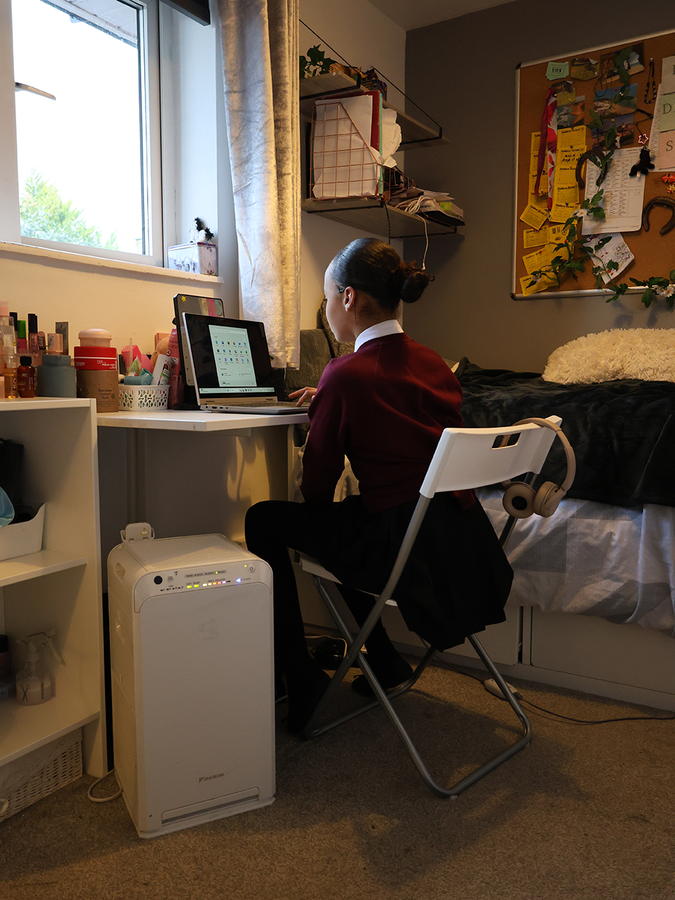Mia working at desk with air purifier