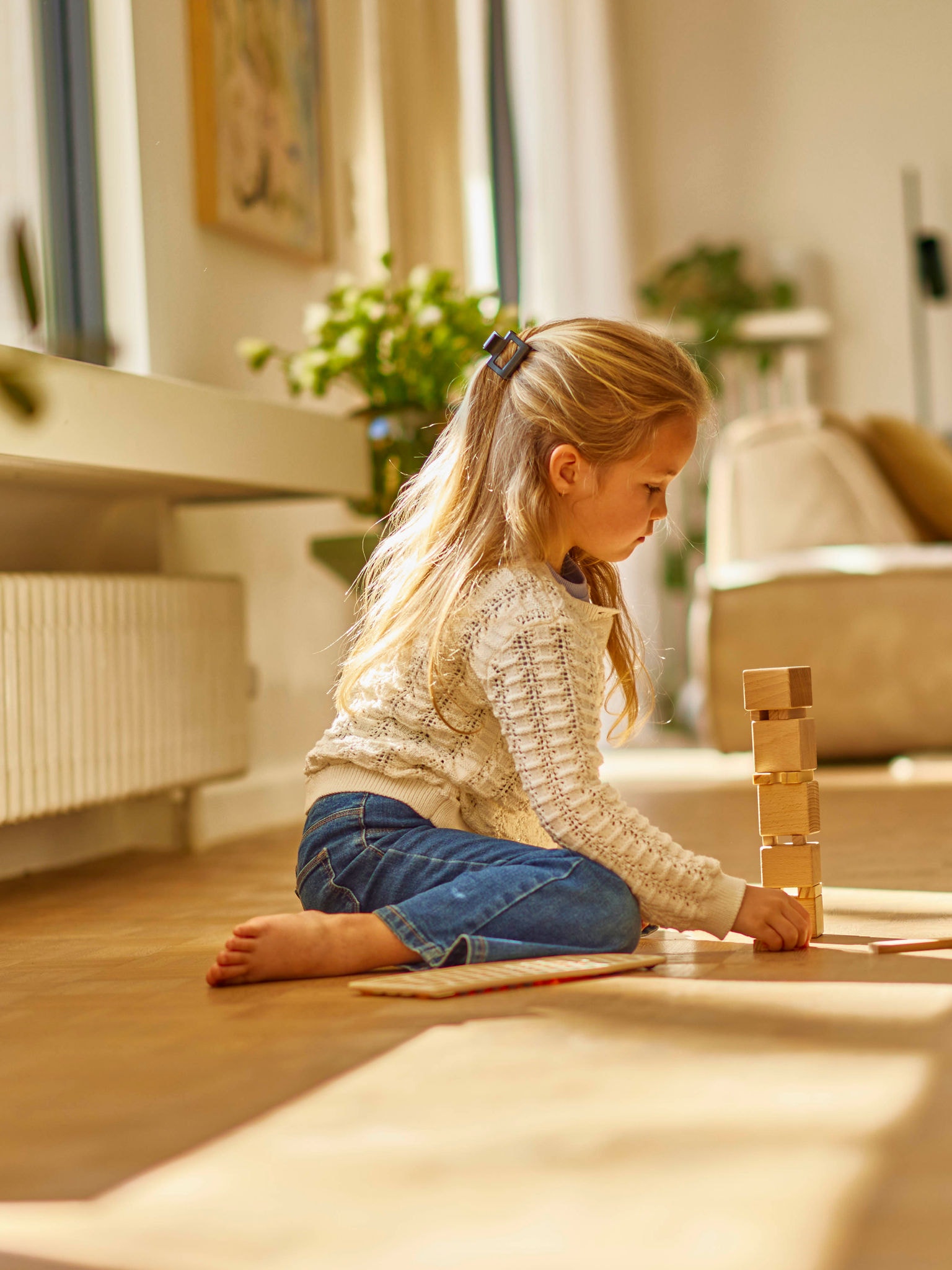 Child playing by radiator