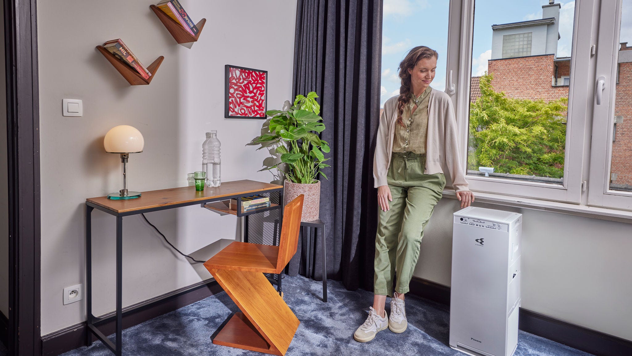Woman turning on air purifier to improve indoor air and reduce allergens