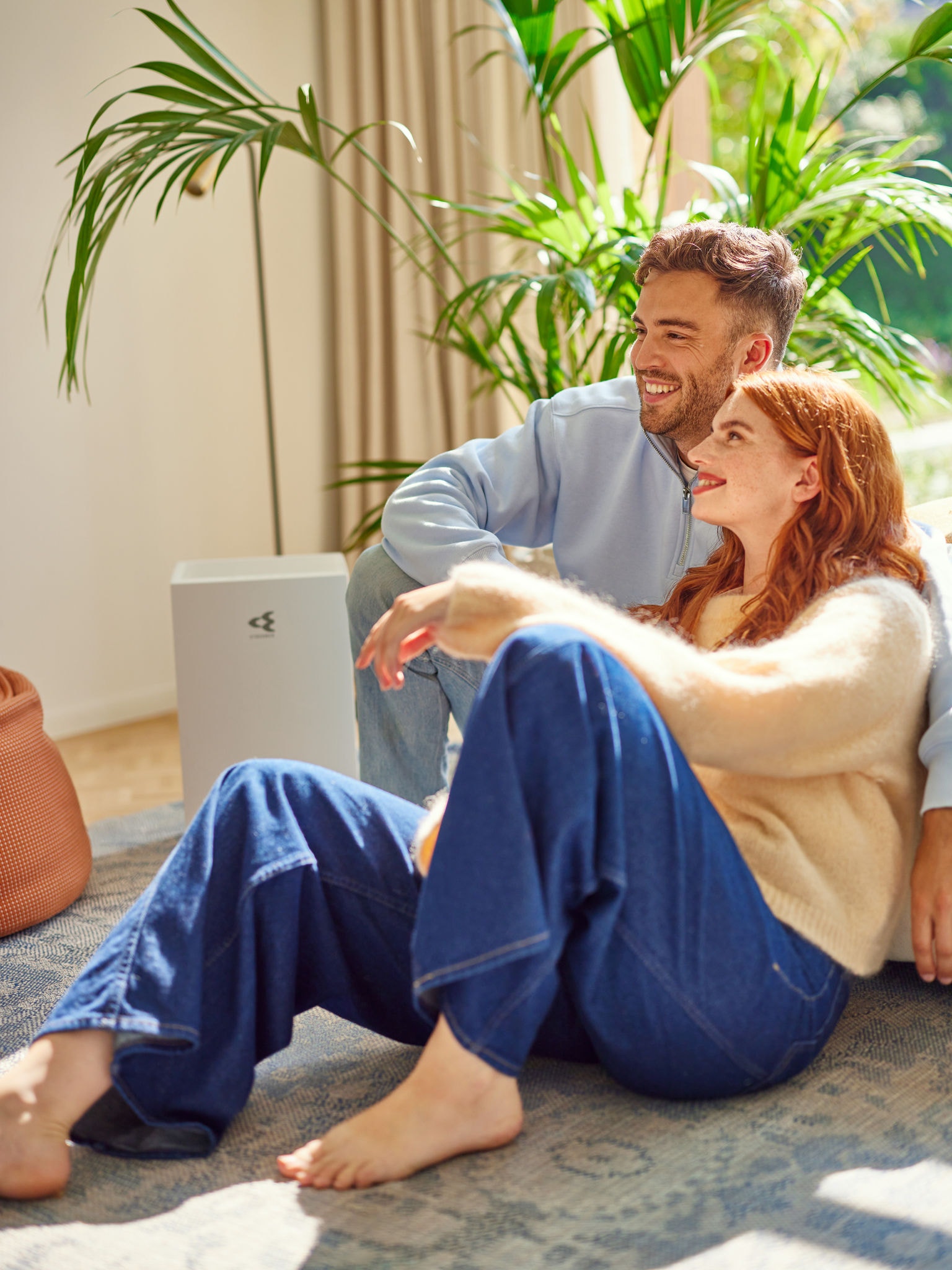 Couple turning on air purifier after cooking to avoid household smells