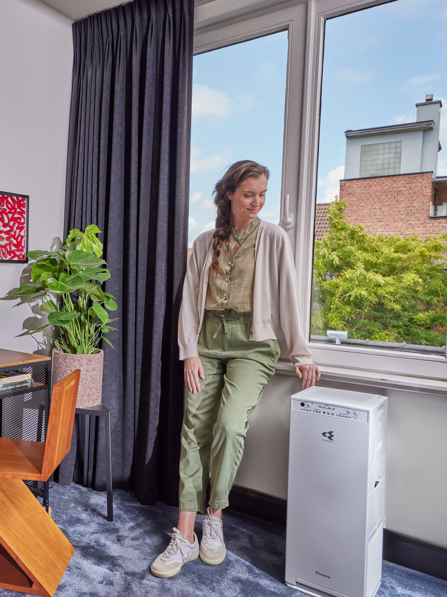 Woman standing beside her air purifier