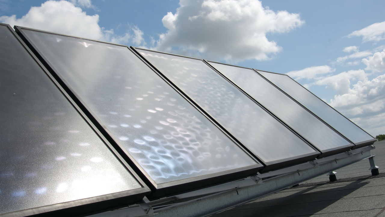 Solar panels installed on roof and linked to Daikin heat pump to create synergy and save money